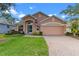 Attractive single-story house with a two-car garage and well-maintained lawn at 4068 Carteret Dr, Winter Haven, FL 33884
