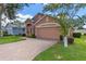 Charming one-story home with a brick driveway and American flag at 4068 Carteret Dr, Winter Haven, FL 33884