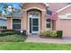 Front entryway with a green door, brick walkway, and American flag at 4068 Carteret Dr, Winter Haven, FL 33884