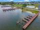 Several wooden docks extending into a calm lake at 4068 Carteret Dr, Winter Haven, FL 33884