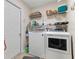 Convenient laundry room with washer, dryer, and storage shelving at 4068 Carteret Dr, Winter Haven, FL 33884
