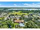 Aerial view of community with lake, pool, and clubhouse at 4265 Cerimen St, Lake Wales, FL 33898