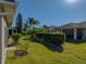 Landscaped backyard with lush greenery and a privacy hedge at 4413 Strathmore Dr, Lake Wales, FL 33859