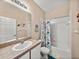 Bathroom with tub shower, single vanity, and view of bedroom at 4413 Strathmore Dr, Lake Wales, FL 33859