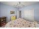 Light blue bedroom with double door closet and ceiling fan at 4413 Strathmore Dr, Lake Wales, FL 33859