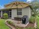 Private backyard patio with grill and umbrella for outdoor dining at 4489 Strathmore Dr, Lake Wales, FL 33859