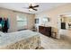 Bright bedroom with wood floors, ceiling fan, and ample closet space at 4489 Strathmore Dr, Lake Wales, FL 33859