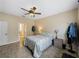 Bright bedroom with ceiling fan, tile flooring, and access to bathroom at 4489 Strathmore Dr, Lake Wales, FL 33859