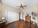 Bedroom with wood floors, ceiling fan, and built-in wardrobe at 4489 Strathmore Dr, Lake Wales, FL 33859