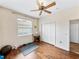 Bedroom with wood floors, ceiling fan, and double doors to closet at 4489 Strathmore Dr, Lake Wales, FL 33859