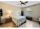 Comfortable bedroom with ceiling fan, tile flooring, and ample closet space at 4489 Strathmore Dr, Lake Wales, FL 33859