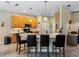 Modern kitchen with an L-shaped island and light wood cabinets at 4489 Strathmore Dr, Lake Wales, FL 33859