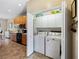 Convenient laundry closet with washer and dryer included in the kitchen area at 4489 Strathmore Dr, Lake Wales, FL 33859