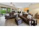 Bright living room with recessed lighting, leather sofas, and access to backyard at 4489 Strathmore Dr, Lake Wales, FL 33859