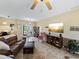 Spacious living room with leather sofas, large TV and access to the front door at 4489 Strathmore Dr, Lake Wales, FL 33859