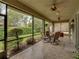 Spacious screened lanai with seating area and tranquil backyard view at 4489 Strathmore Dr, Lake Wales, FL 33859