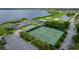 Two tennis courts with lake and golf course views at 4489 Strathmore Dr, Lake Wales, FL 33859