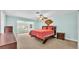 Relaxing bedroom with coral bedding and a ceiling fan at 48 Nottingham Way, Haines City, FL 33844