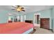 Spacious bedroom with coral bedding and ensuite bathroom at 48 Nottingham Way, Haines City, FL 33844