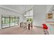 Dining area with a glass-top table and chairs, adjacent to the kitchen at 48 Nottingham Way, Haines City, FL 33844