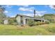 Ranch style home with mature landscaping and a large yard at 48 Nottingham Way, Haines City, FL 33844