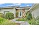 Front entry features a stone facade, landscaped walkway, and a welcoming entrance at 48 Nottingham Way, Haines City, FL 33844