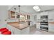 White kitchen with stainless steel appliances and light countertops at 48 Nottingham Way, Haines City, FL 33844