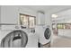 Bright laundry room with Samsung washer and dryer and view to kitchen at 48 Nottingham Way, Haines City, FL 33844