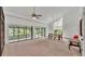 Spacious living room with high ceilings, sliding glass doors, and a dining area at 48 Nottingham Way, Haines City, FL 33844