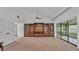 Living room features built-in shelving and sliding doors leading to a patio at 48 Nottingham Way, Haines City, FL 33844