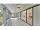 Spacious screened porch with tile flooring and ceiling fan at 48 Nottingham Way, Haines City, FL 33844