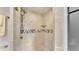 Walk-in shower with tile surround and decorative accents at 48 Nottingham Way, Haines City, FL 33844
