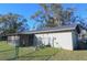 Home's back exterior, showing garage and fence at 5090 Misty Lake Dr, Mulberry, FL 33860