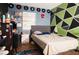 Bedroom with a bed, geometric wall art, and a window at 5090 Misty Lake Dr, Mulberry, FL 33860