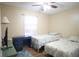 Bedroom with twin beds, desk, and window with curtains at 5090 Misty Lake Dr, Mulberry, FL 33860