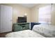 Bedroom with twin beds, dresser, and window with curtains at 5090 Misty Lake Dr, Mulberry, FL 33860