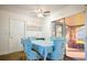 Bright dining room with light blue chairs and a view to the backyard at 5090 Misty Lake Dr, Mulberry, FL 33860