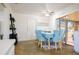 Bright dining room with light blue chairs and a view to the backyard at 5090 Misty Lake Dr, Mulberry, FL 33860