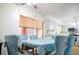 Dining area with blue chairs and access to the kitchen at 5090 Misty Lake Dr, Mulberry, FL 33860