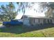 Single-story home with a two-car garage and landscaped yard at 5090 Misty Lake Dr, Mulberry, FL 33860
