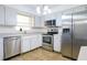 Kitchen with stainless steel appliances and light gray cabinets at 5090 Misty Lake Dr, Mulberry, FL 33860