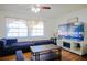 Living room with sectional sofa and large TV at 5090 Misty Lake Dr, Mulberry, FL 33860