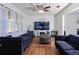 Living room with dark couches and a large TV at 5090 Misty Lake Dr, Mulberry, FL 33860