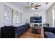Living room with dark couches and wood floors at 5090 Misty Lake Dr, Mulberry, FL 33860