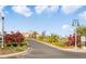 Landscaped entrance to community clubhouse with palm trees and a paved driveway at 523 Brookeshire Dr, Davenport, FL 33837
