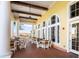 Covered patio with wooden tables and chairs, offering a relaxing outdoor space at 523 Brookeshire Dr, Davenport, FL 33837