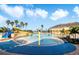 Resort-style pool with a water slide, mushroom fountain, and plenty of lounge chairs at 523 Brookeshire Dr, Davenport, FL 33837