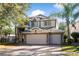 Two-story house with three-car garage and stone accents at 523 Brookeshire Dr, Davenport, FL 33837