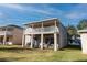 Two-story house with balcony, backyard patio and basketball hoop at 523 Brookeshire Dr, Davenport, FL 33837