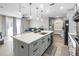 Modern kitchen with gray cabinets, large island, and stainless steel appliances at 523 Brookeshire Dr, Davenport, FL 33837